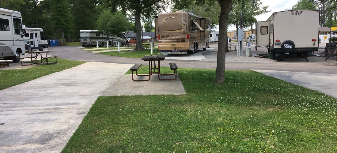 SITE 34 IS AN EXAMPLE OF ONE OF OUR FULL HOOKUP PULL-THRU SITES FEATURING A CONCRETE SLAB WITH PATIO WITH PICNIC TABLE, GRASS YARD, WATER, SEWER, 50/30/20 AMP ELECTRICITY, CABLE, AND WIRELESS INTERNET.