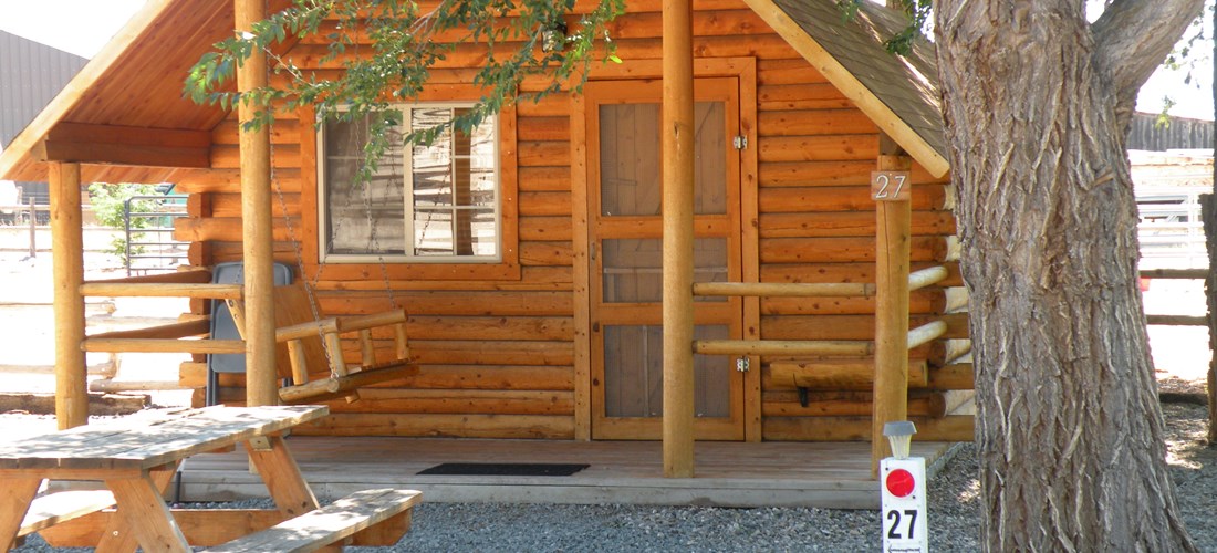One room cabin Rustic design Has power outlet, tv, one double bed, a set of bunkbeds.  Bring your own bedding. Use our showers and restrooms