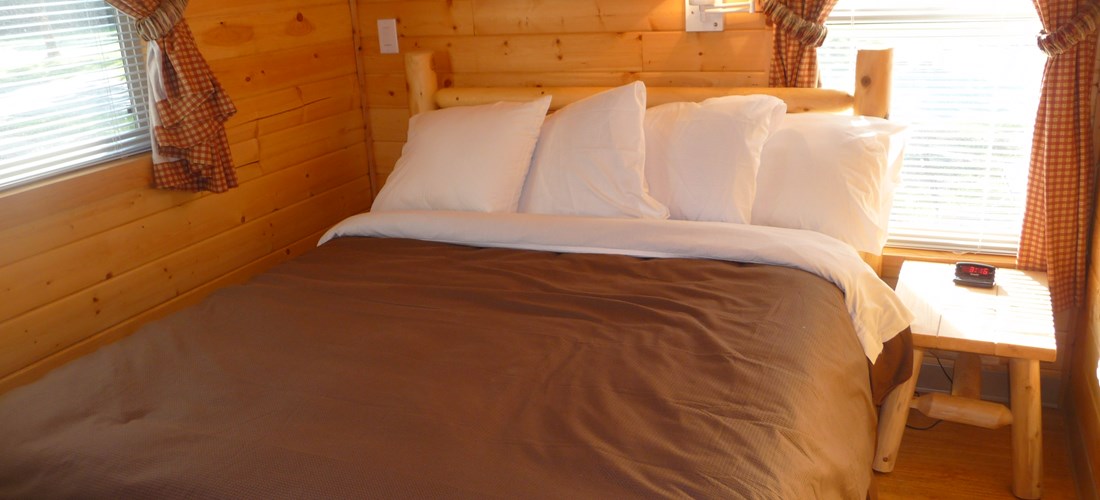 Cabin has a private bedroom with queen bed.