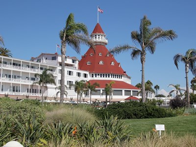 Scenic shot of the Coronado Hotel with its iconic red octahedral roof and white terraces.