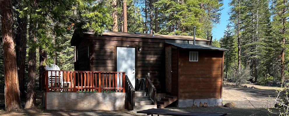 Stay at our cabin that has a queen bed and 2 sets of 3 bunk beds. Air conditioner, TV, microwave, and a private bathroom.  Call us to book your reservation at 530-335-7418.