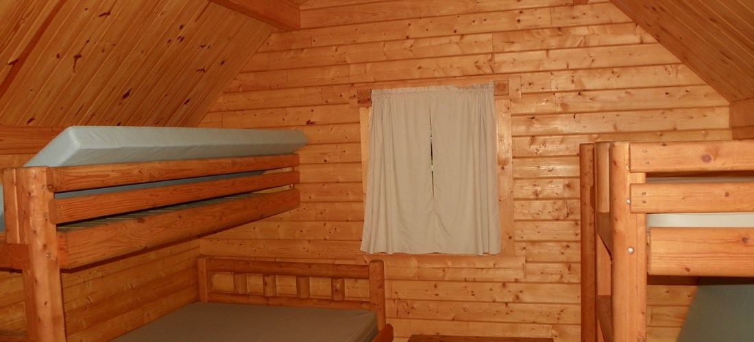 Inside camping cabin with extra bunk. Not all camping cabins have an extra bunk. Please call for specifics.