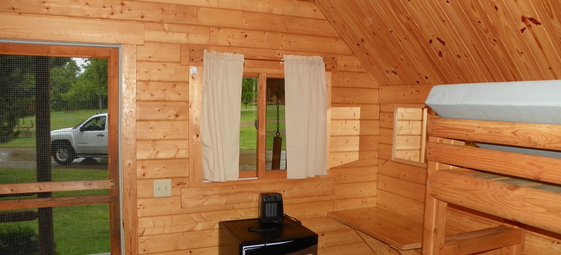 Inside camping cabin with extra bunk. Not all camping cabins have an extra bunk. Please call for specifics.