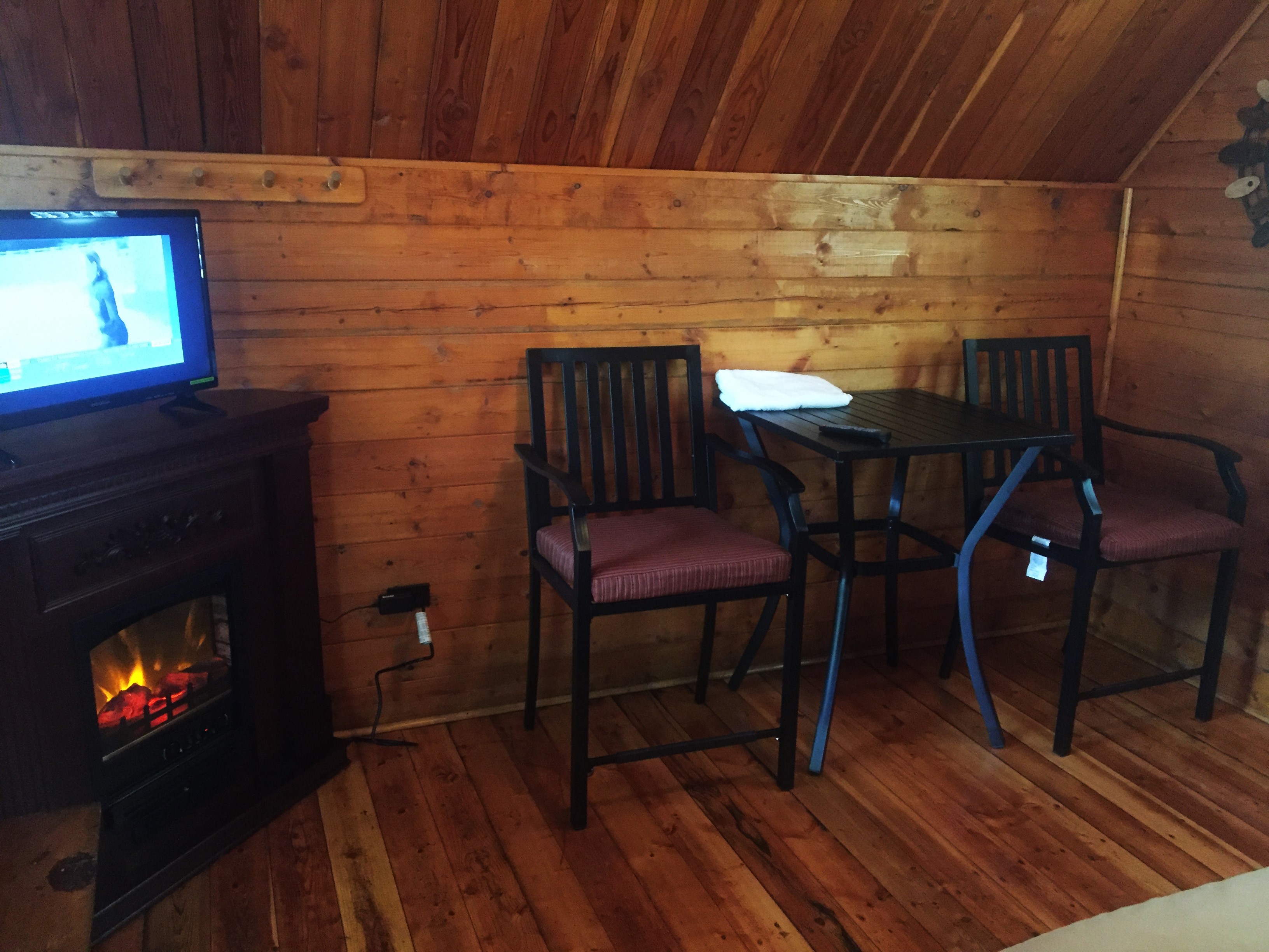Inside Couple's Cabin Electric Fireplace & Bistro Set