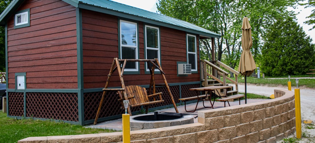 Studio lodge with large brick patio. Enjoy your campfire and watch your barbecue  sizzle from the comfort of a patio swing!