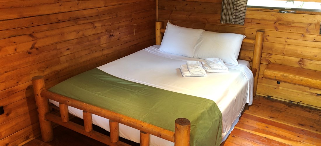 Camping Cabin full-size bed (shown with linen package).