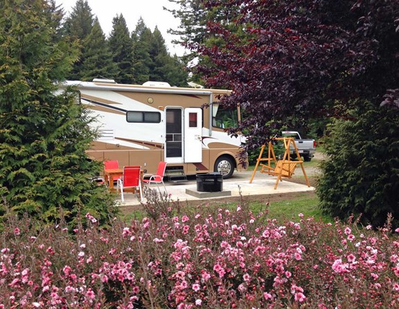 New Deluxe RV sites have full hook-ups, concrete patio, table and chairs, fire experience and a swing. Enjoying RVing in STYLE!