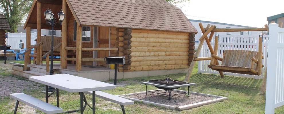 Our one room camping cabin comes with a double bed, a set of bunks, heat, a/c, cable tv, picnic table, front porch seating and gas grill. Enjoy the rabbits and the occasional Jackalope. Restrooms located close by along with the pool and playground.