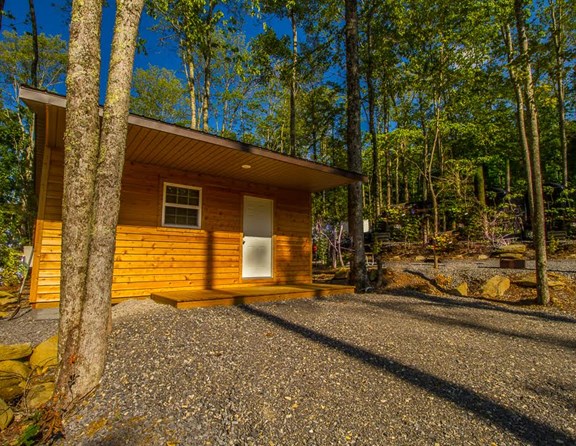 Our cabins can hold 2 adults and 2 children.  Kitchen with microwave, coffee pot and refrigerator and a full bathroom