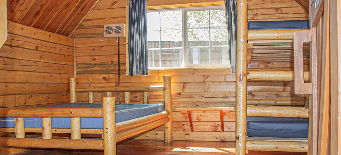 Our One Room Camping Cabins are cozy, and sleep up to four people!