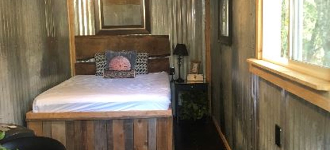 Cute, cozy, and clean, this rustic-chic shipping container turned camping cabin