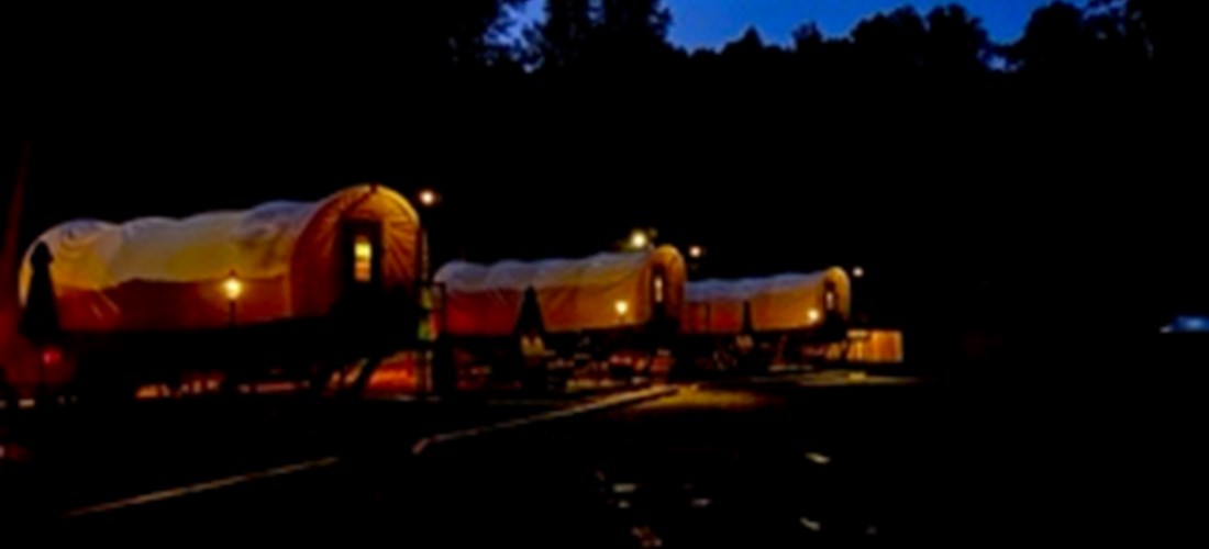Covered wagons at night