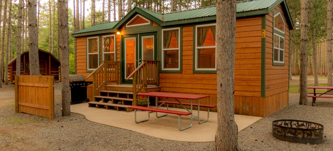 Luxury in the pines.  These deluxe cabins are family ready with kitchenettes, baths, patios, grills, fire rings and more.  They sleep 6 in a variety of floor-plans.  Your's awaits!