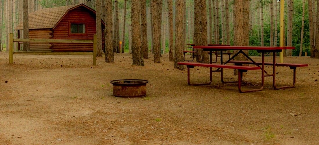 Sleeping under the stars and pines!  Our tent sites are wonderful.  Each comes with a picnic table, fire ring and most have easy access to our community camping kitchen with sinks and stove tops.  Deluxe tent sites include crushed sand pads and electric hookups.  Come find your special spot in the beautiful Northwoods.
