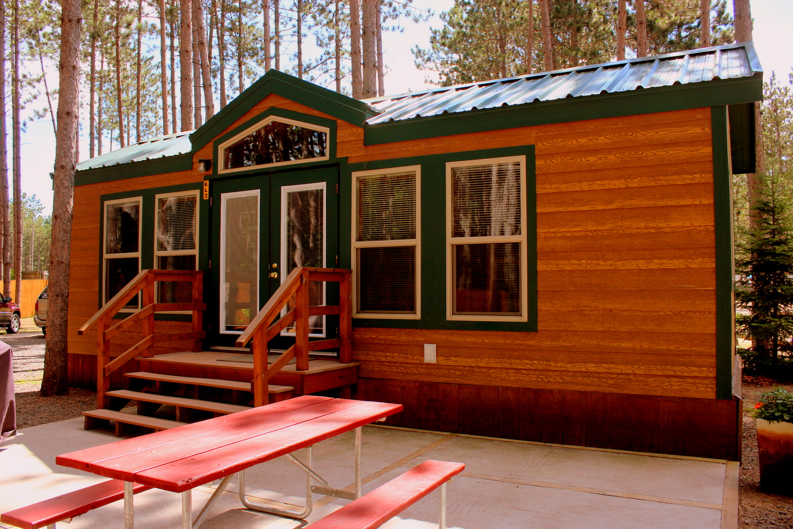 Luxury in the pines.  These deluxe cabins are family ready with kitchenettes, baths, patios, grills, fire rings and more.  They sleep 6 in a variety of floor-plans.  Your's awaits!