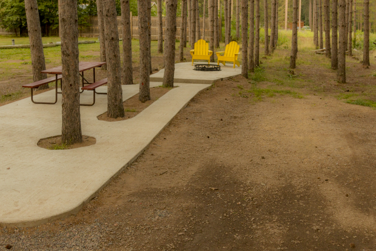 Patios, fire rings, seating and tables - our deluxe RV sites are the place to sit back and relax under the tall pines.  Back-ins or pull-throughs, your favorite space awaits!