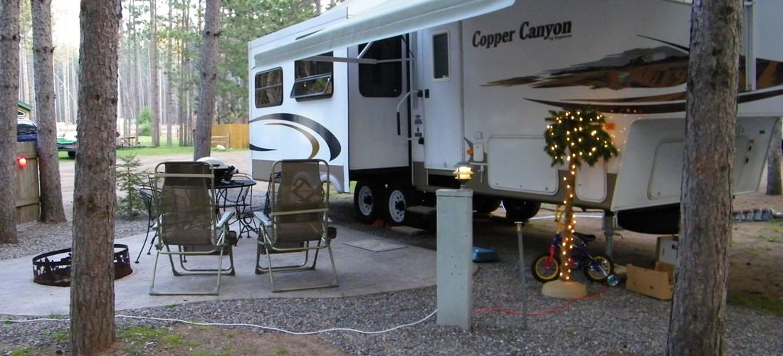 Patios, fire rings, seating and tables - our deluxe RV sites are the place to sit back and relax under the tall pines.  Back-ins or pull-throughs, your favorite space awaits!