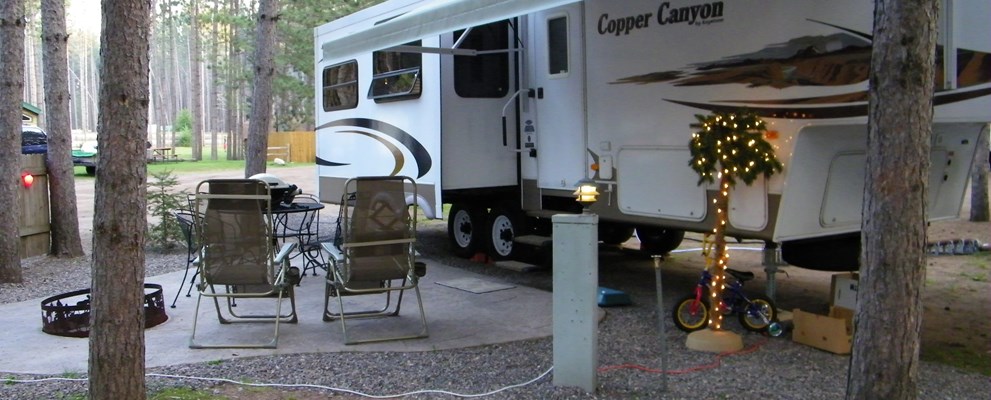 Patios, fire rings, seating and tables - our deluxe RV sites are the place to sit back and relax under the tall pines.  Back-ins or pull-throughs, your favorite space awaits!