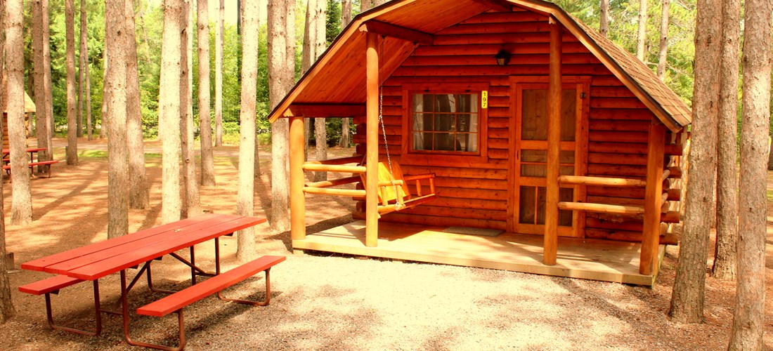 Enjoy our beautiful rustic cabins nestled in the pines.  They are either one bedroom sleeping 4 or two bedrooms sleeping 6.  All have porches, fire rings and picnic table.  Why stay in a motel?