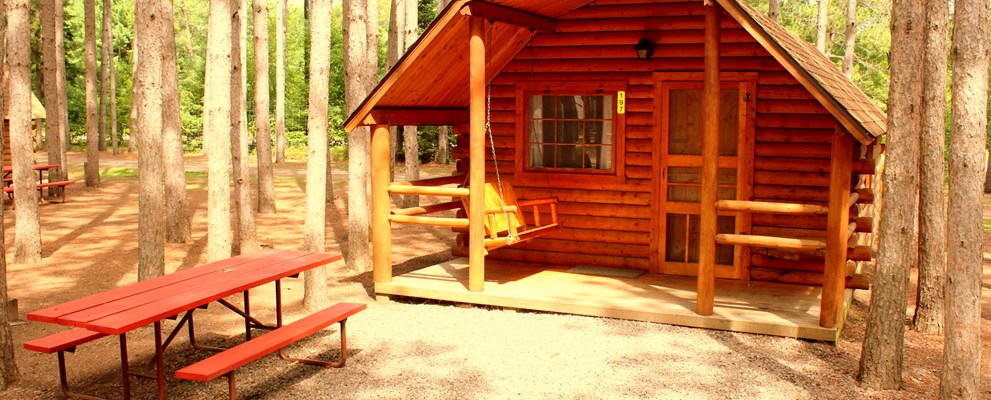 Enjoy our beautiful rustic cabins nestled in the pines.  They are either one bedroom sleeping 4 or two bedrooms sleeping 6.  All have porches, fire rings and picnic table.  Why stay in a motel?