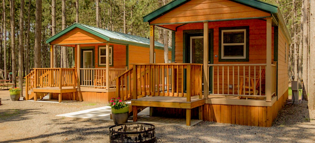 Wow!  These beautiful deluxe studio cabins, sleeping either 4 or 6,  come with full baths, stocked kitchenettes, patios, grills and fun!  Nestled in the trees near our beautiful heated pool and other amenities, they are family fun ready!