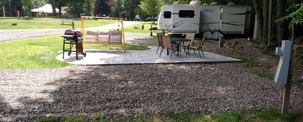 Deluxe Patio back-in site, Shady with some morning sun. Woodlands behind the site.