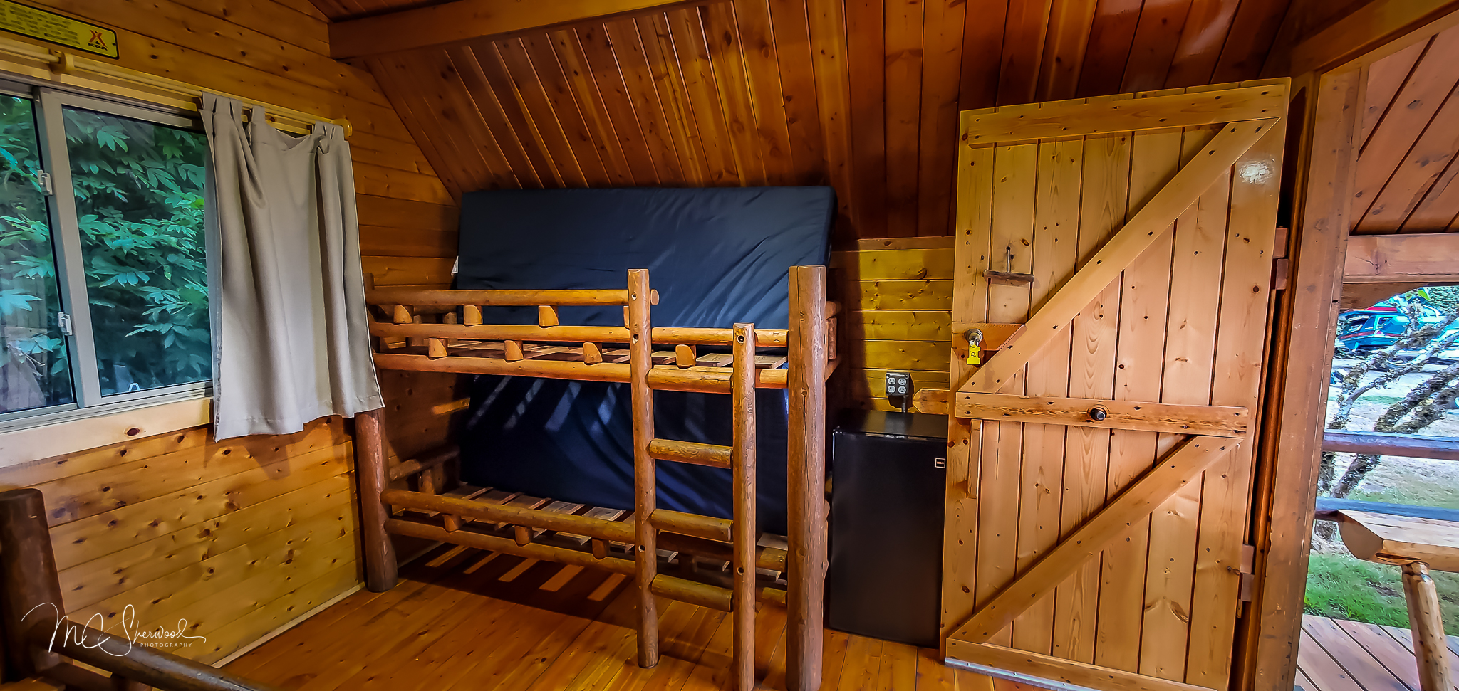 One-room rustic camping cabin interior - bunk beds