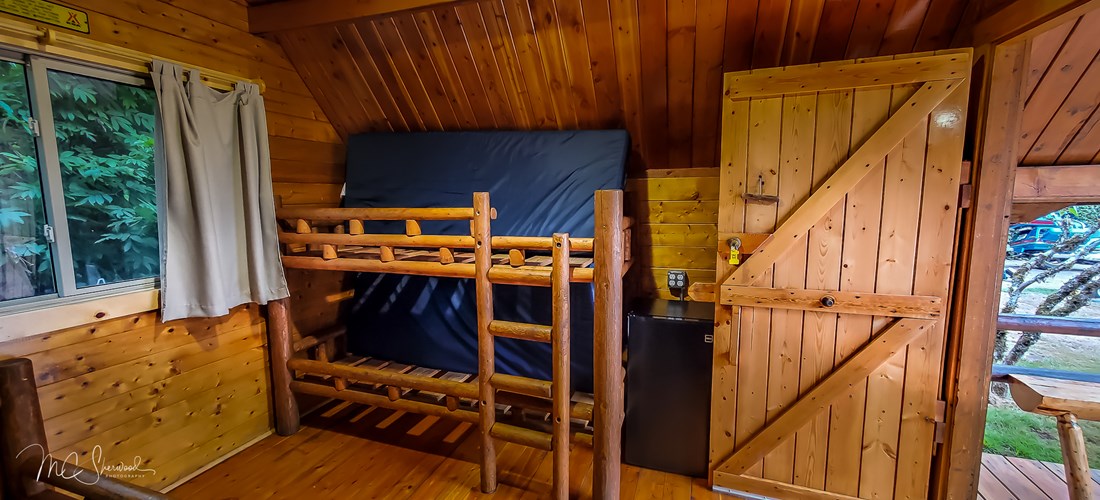 One-room rustic camping cabin interior - bunk beds