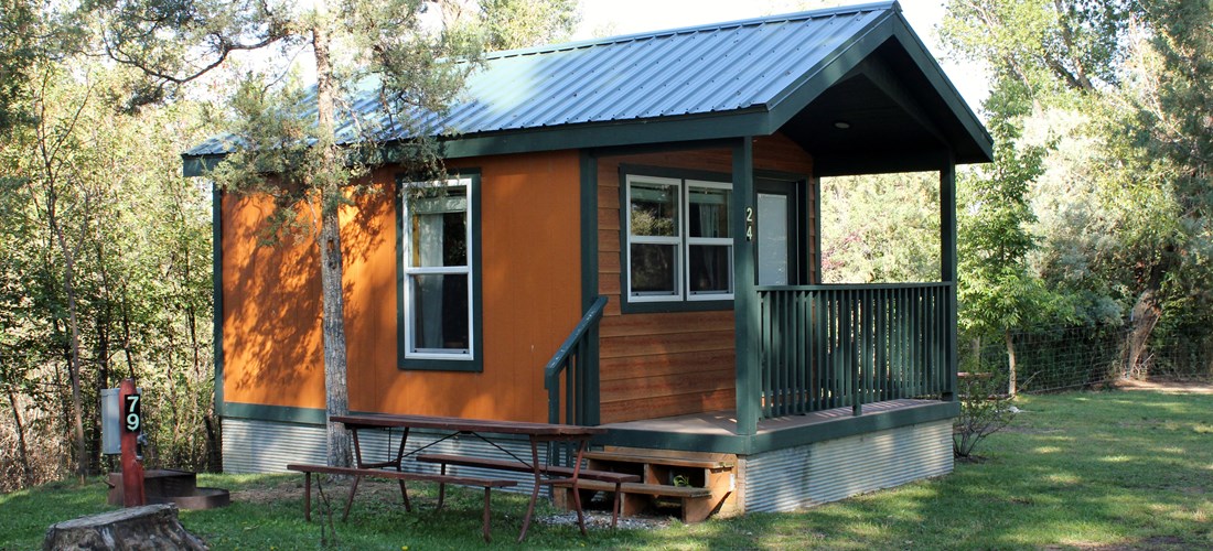 Cabin #24 offer a half bath, mini fridge, and a microwave. Located on the peaceful and shady north end right across from a bath house.