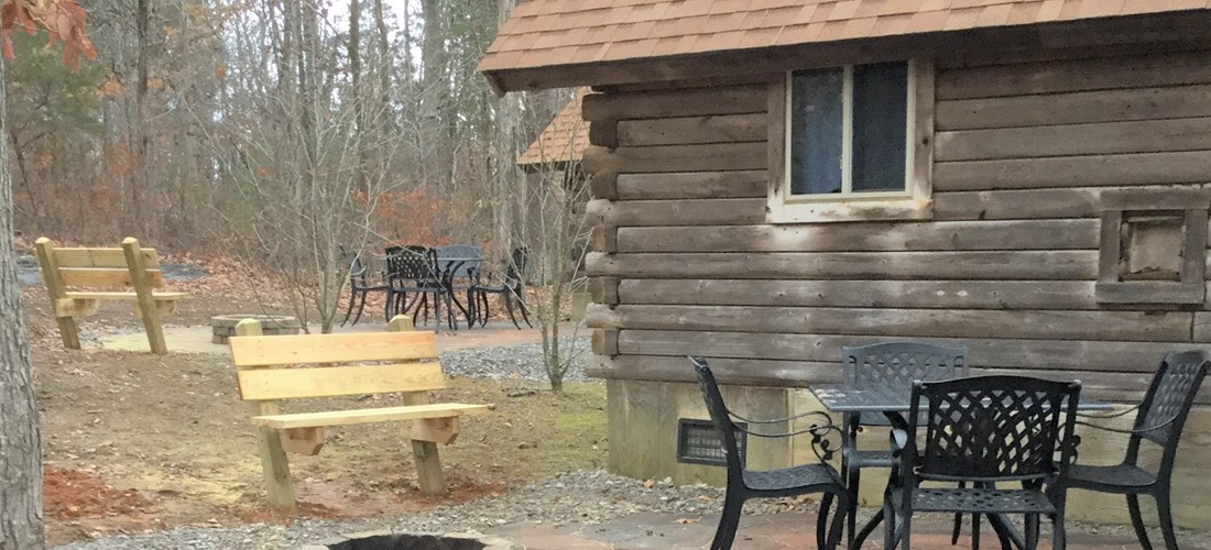 A view of the patio area behind a deluxe cabin.