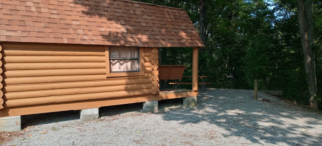 Deluxe cabin, 1/2 bath. Faces woods, close to tenting area. Sleeps 3.