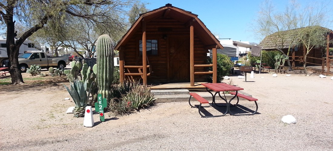 1 Room Camping Cabin (w/o Bathroom) These log cabins sleep 4 people in a double bed and two bunk beds. Sit in the front porch swing and enjoy the view of the Superstition Mountains or cook dinner on the outdoor grill. No pets!