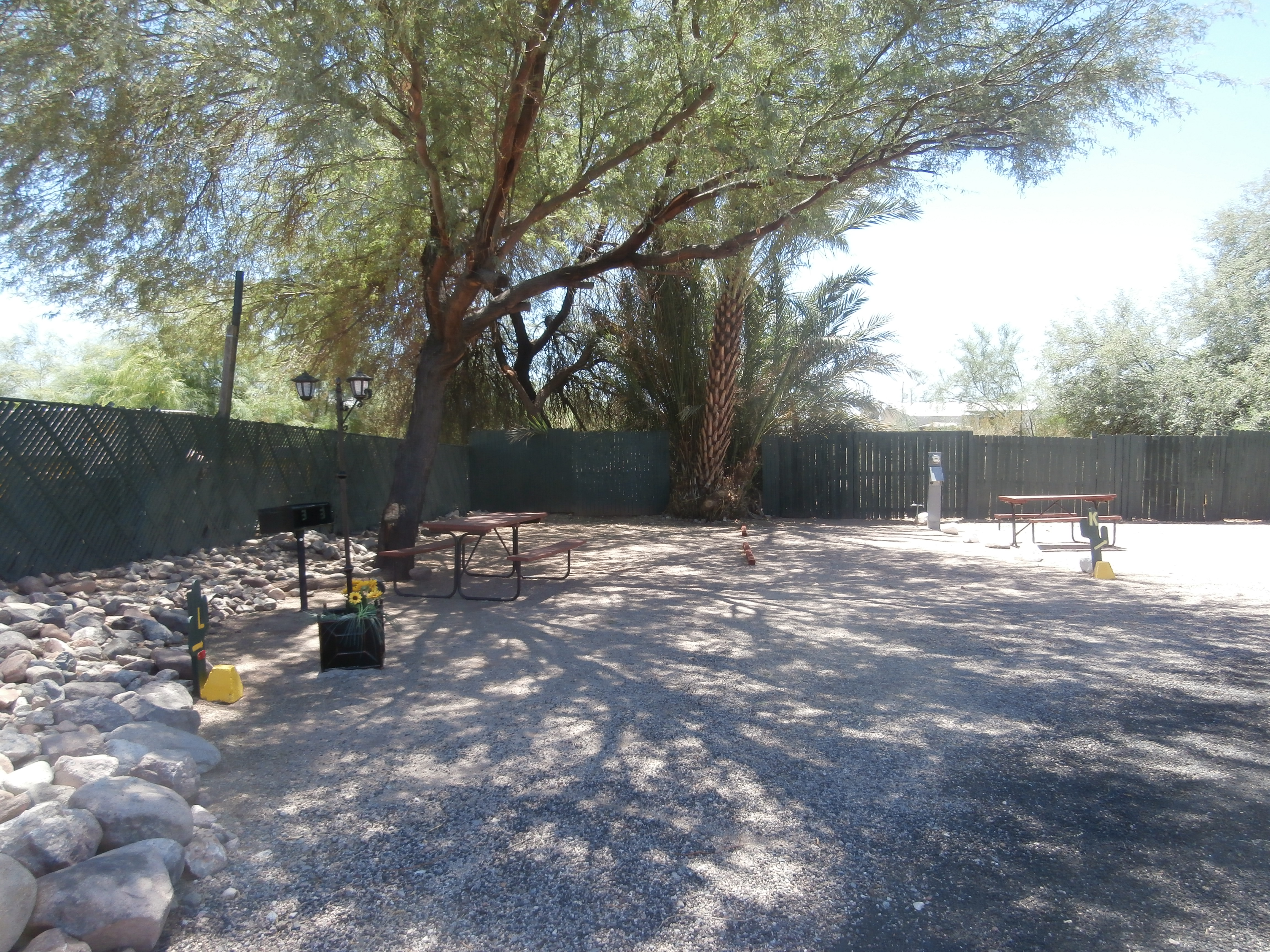 Tent Site, Water/Electric, Gravel Site Pad Enjoy a spacious water and electric site with a charcoal grill, picnic table and shade trees