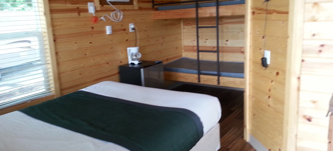 Deluxe Cabins K17 and K18 back up to the canal, have  queen bed and sleep loft for the kids, full bath, small fridge, microwave and coffeemaker..