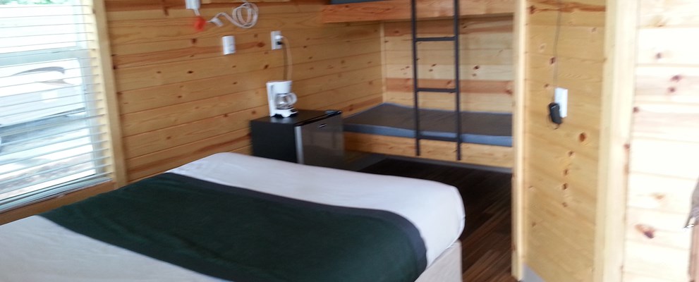 Deluxe Cabins K17 and K18 back up to the canal, have  queen bed and sleep loft for the kids, full bath, small fridge, microwave and coffeemaker..