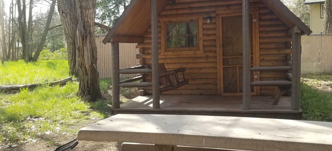 1-Bedroom Camping Cabin. Sleeps up to 4 people. Includes a concrete picnic table and a fire ring with a flip top grill for cooking on the fire ring. Linens provided during winter time.