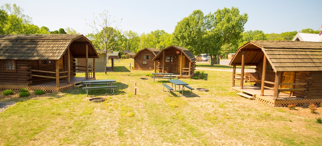Our rustic cabins are conveniently located to the bath-house and come with charcoal grills, fire rings and a picnic table.
