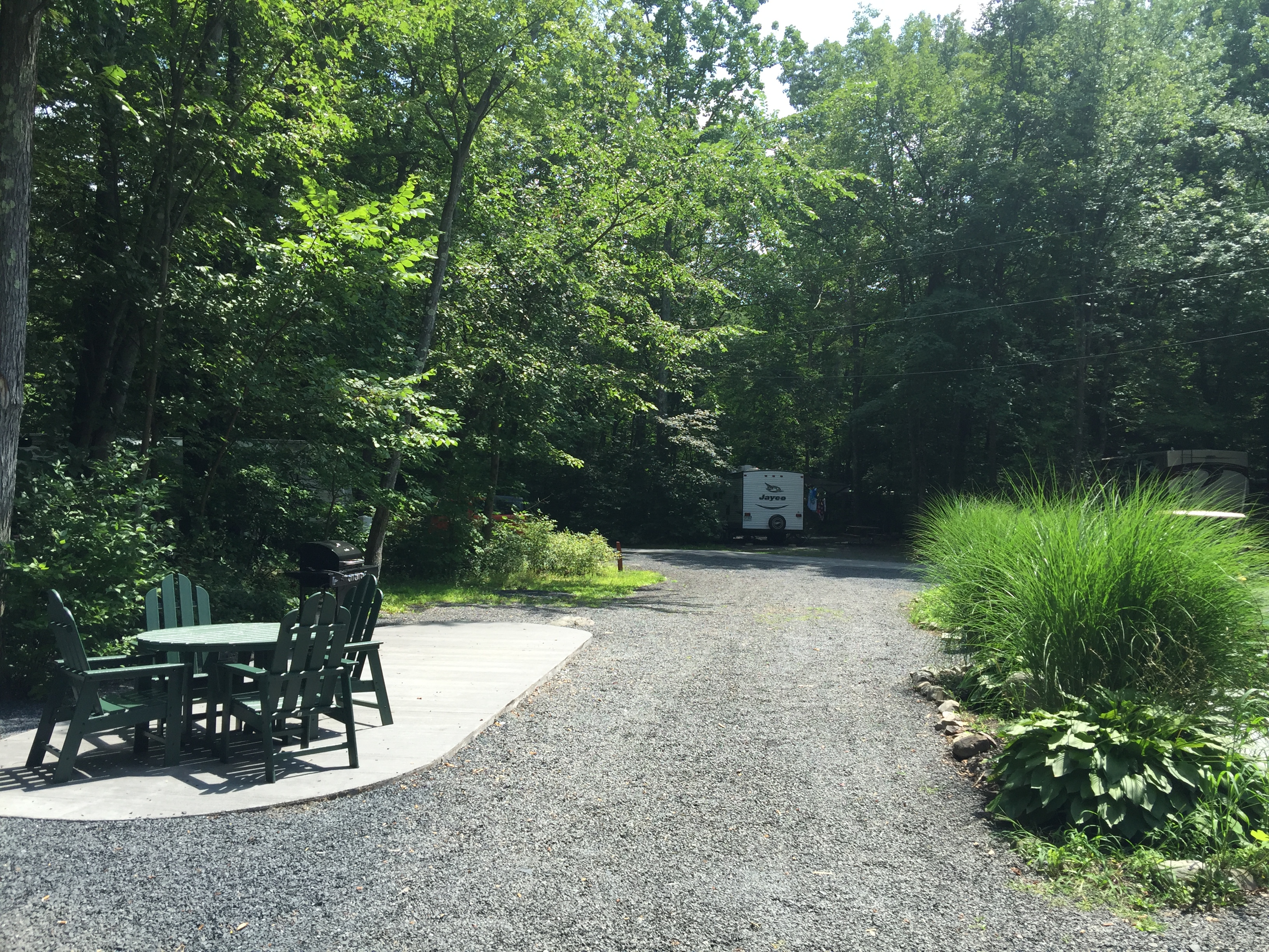 Deluxe Patio Site. Dining Set and Grill Provided. Fire Ring Provided at Every Site. No Picnic Table.