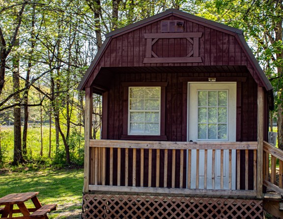 Cozy camping cabin with half bath. Linens not included.