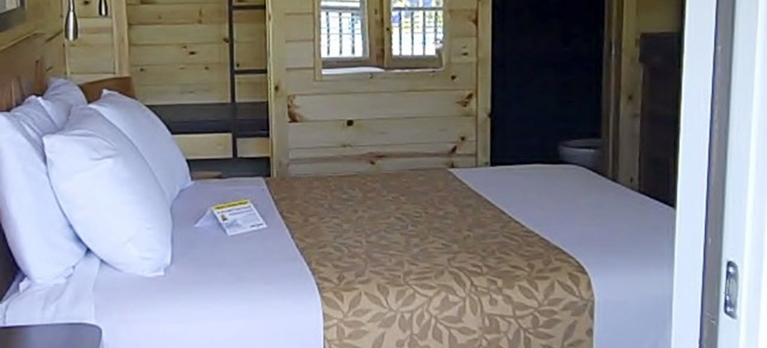 The main room of our studio Deluxe Cabin is very comfortable with a queen bed.
