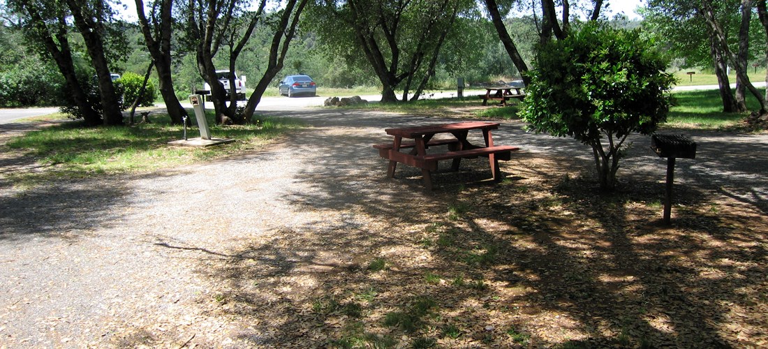 These are water and electric 30 amp pull thru sites which are ideal for very small motorhomes, vans, and tent trailers if disconnecting and parking nearby. Each features a picnic table, bbq grill, wifi access, and HD cable tv. Pictured is site 46.
