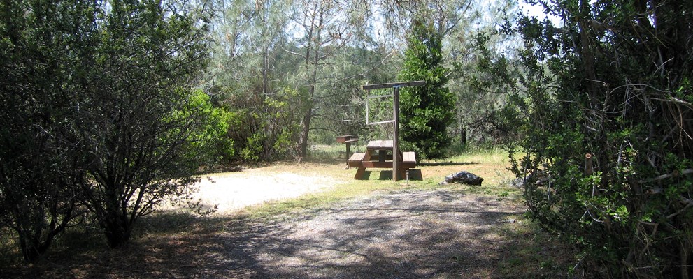 These tent site have only water included and are along the back fence line. It includes a picnic table and bbq grill. Pictured is tent site 67 which is furthest from highway 50 and close to the main building.