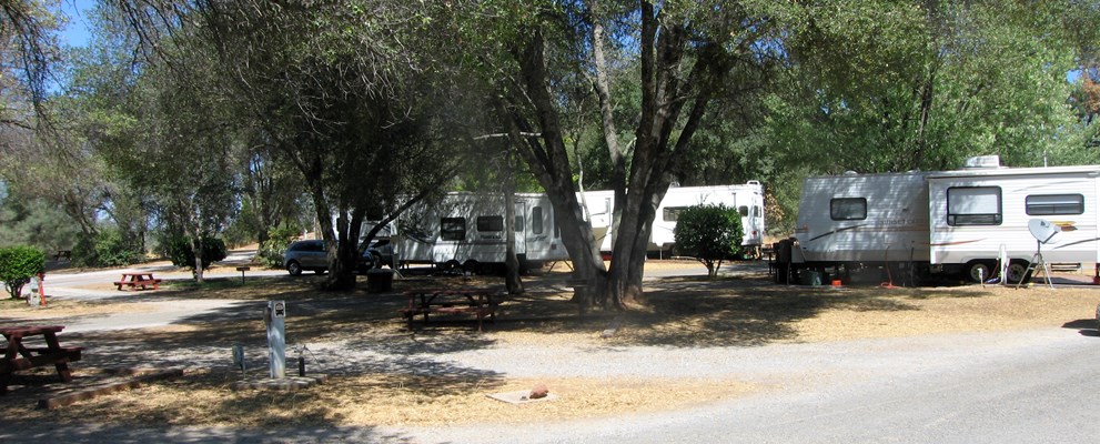 This unique full hookup 30 amp pull thru site is known for it's very large sized picnic area giving families plenty of space. It features a picnic table, bbq grill, wifi access, and HD cable tv. Pictured is site 44.