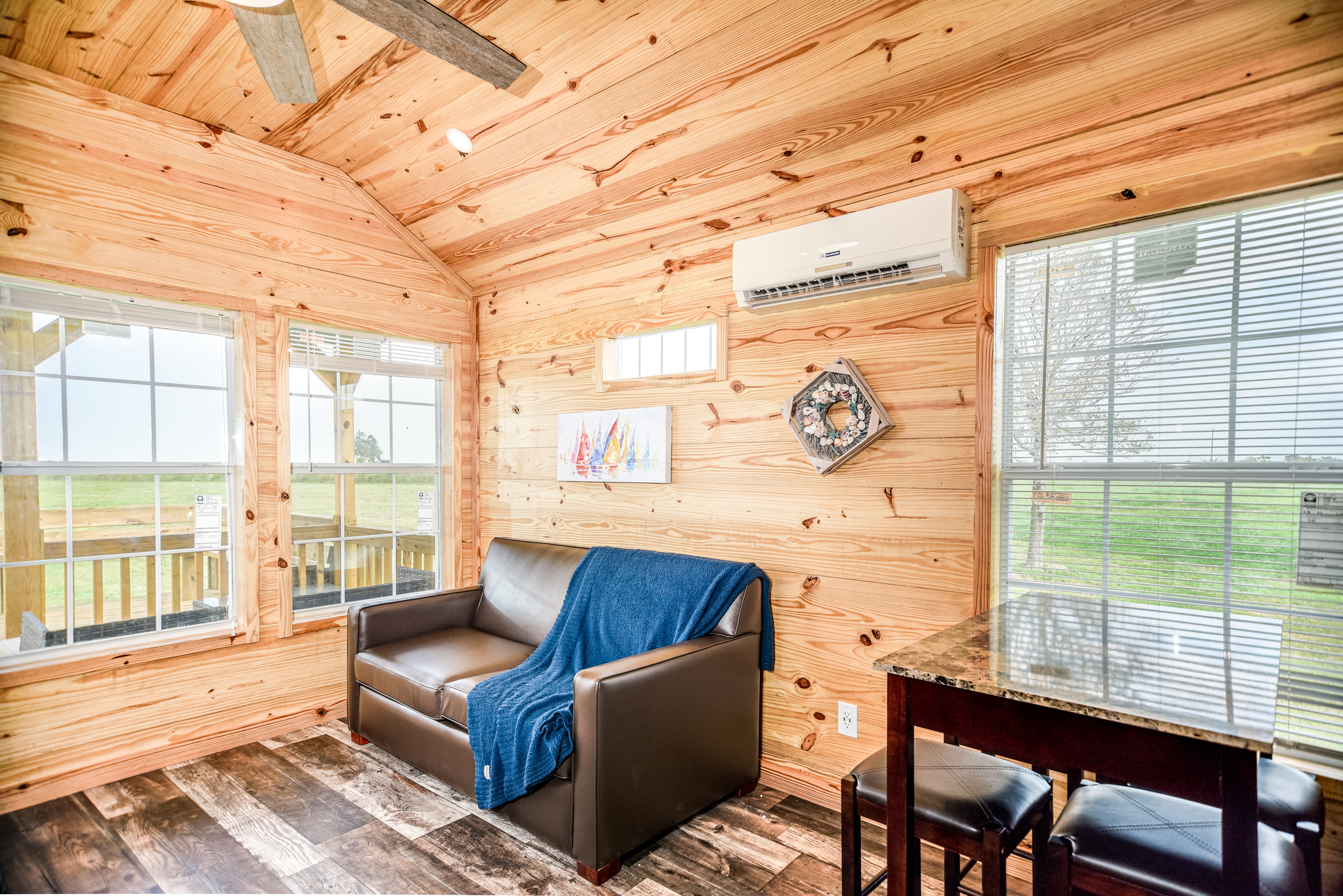 Our one bedroom cabin offers a kitchen area, dining table and a living space to relax on the sofa!
