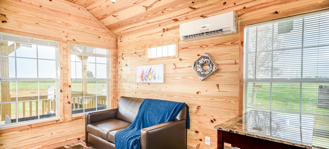 Our one bedroom cabin offers a kitchen area, dining table and a living space to relax on the sofa!