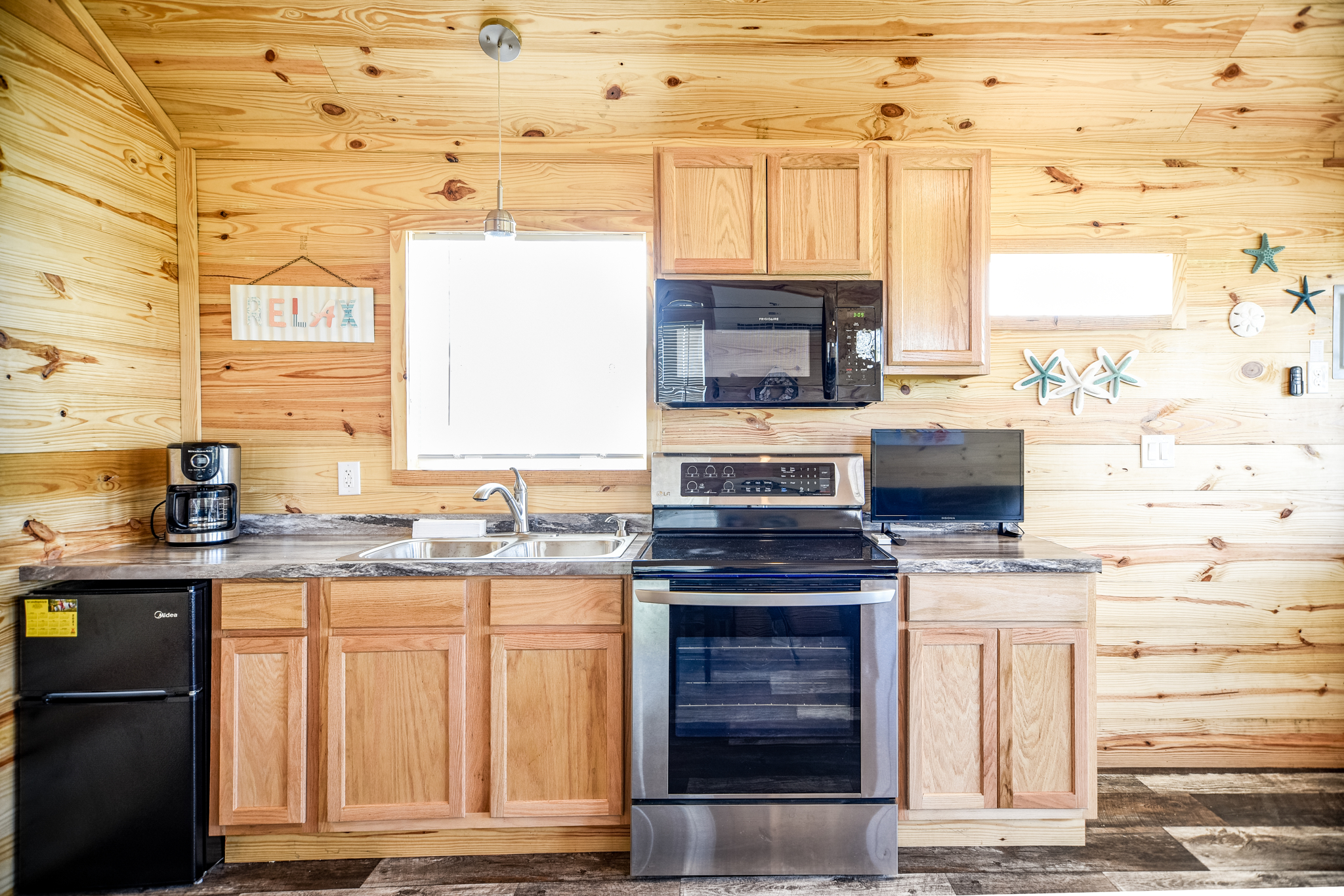 Our one bedroom cabin offers a kitchen area, dining table and a living space to relax on the sofa!
