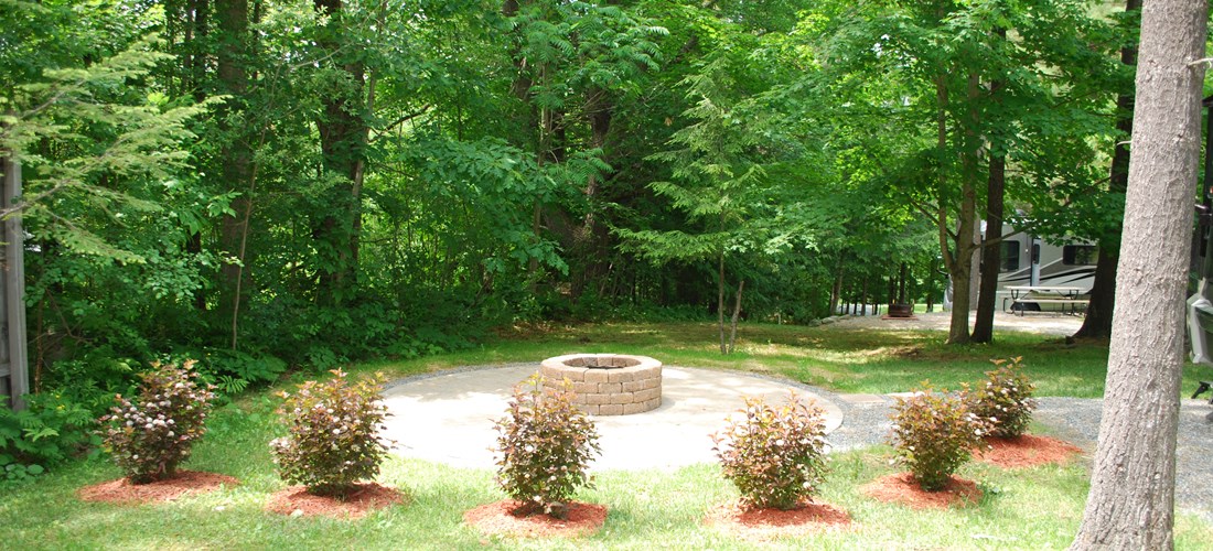 Beautiful view from your front window! Circular pavered patio with deluxe stone firepit.