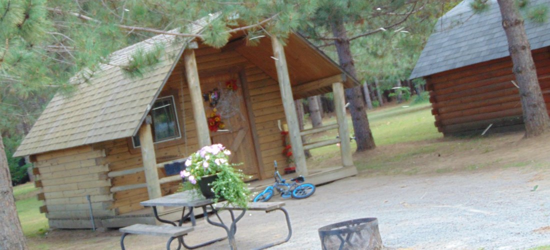 Cabins sleep 4 comfortably, with a mini-fridge, power, fire-pit and picnic table. Beautifully shaded and naturally cool.