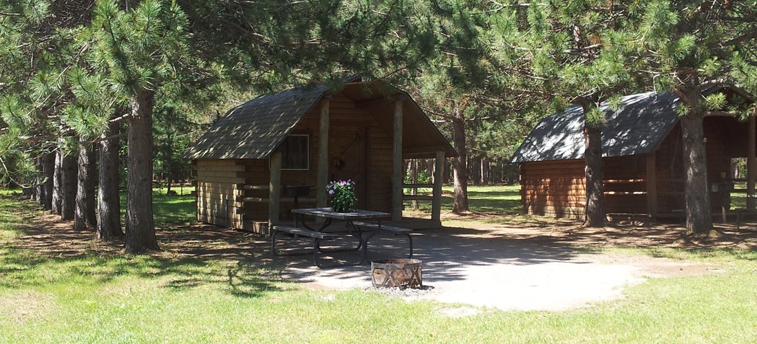 Beautiful cabin set in the pines with view of the lake. Sleeps 4, has power and a mini-fridge included.