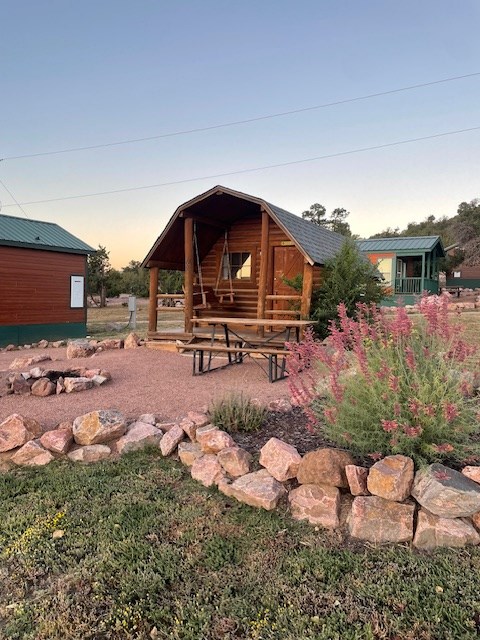 exterior of a cabin with sitting in front